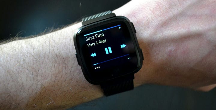 Fitbit smartwatch displaying music control features.