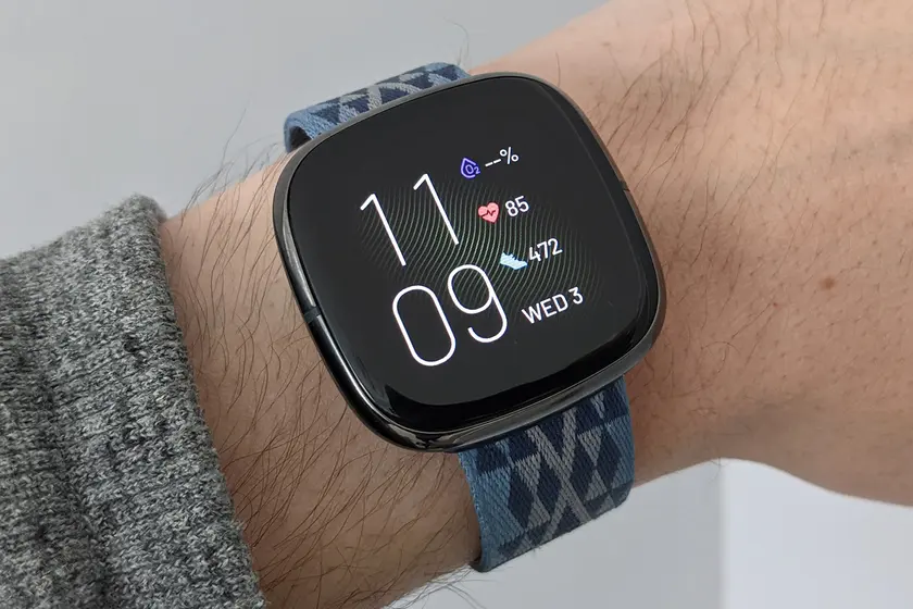 A Fitbit smartwatch displaying fitness tracking features.