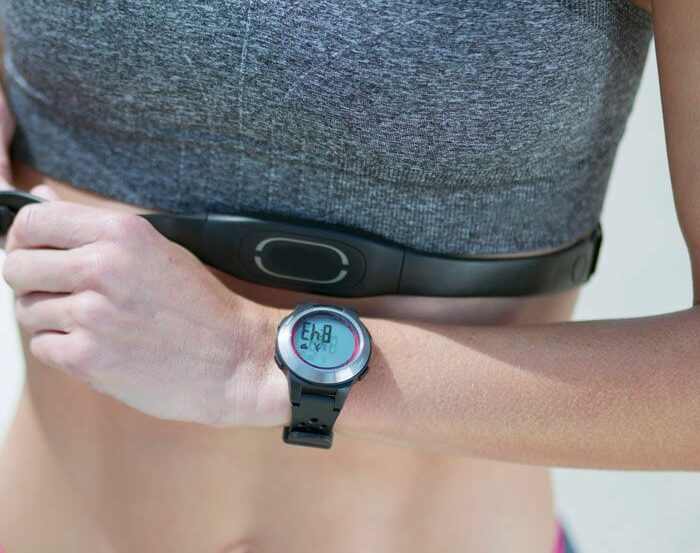 A person wearing a fitness tracker with real-time heart rate monitoring while exercising.