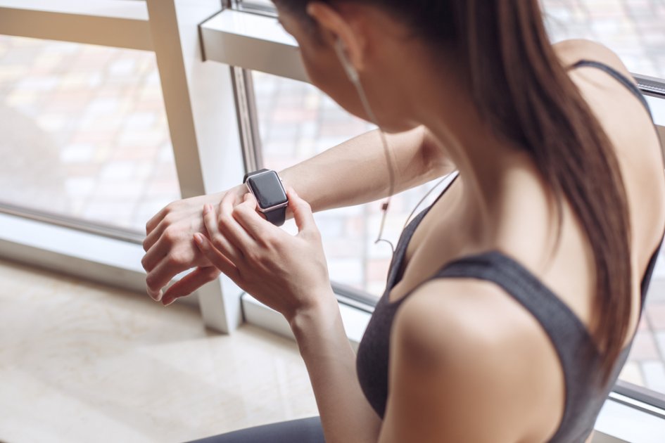 A person monitoring their heart rate during exercise with a fitness tracker.