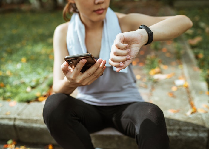 A person wearing a fitness tracker on their wrist, showing heart rate monitoring in progress.