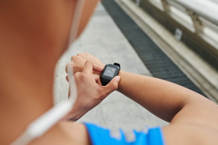 A person using a finger to measure heart rate.