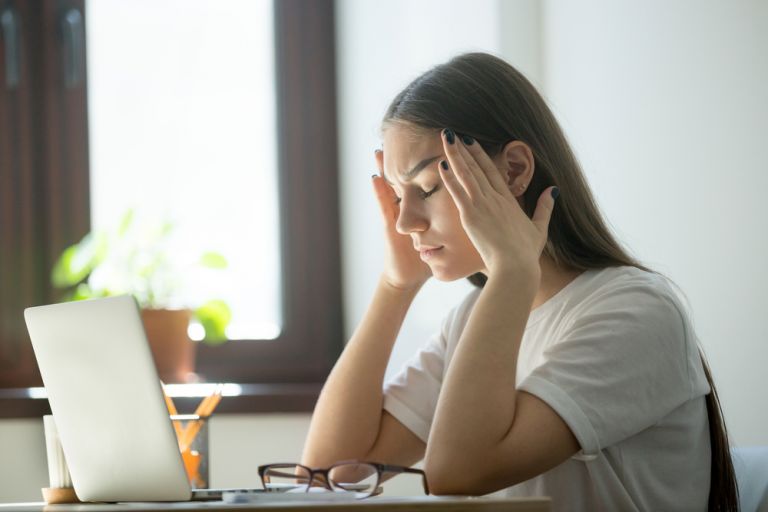 A person using a heart rate monitor to manage stress levels.