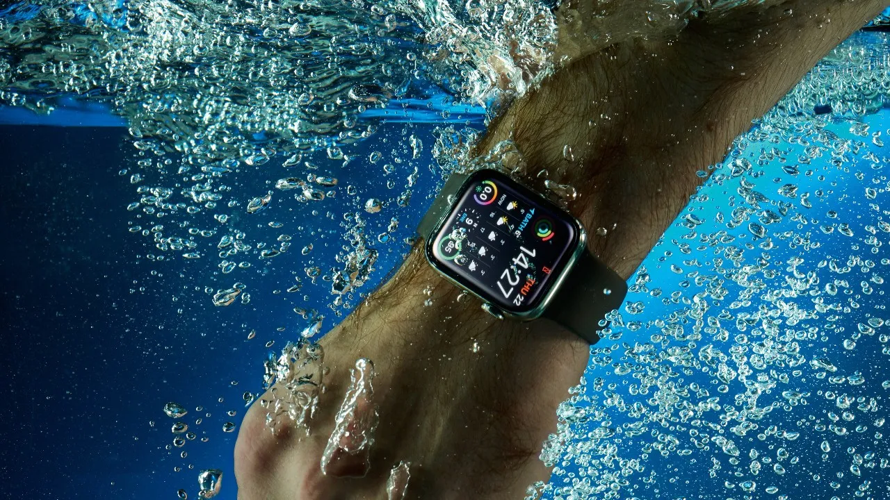 A swim watch with a waterproof design on a swimmer's wrist.