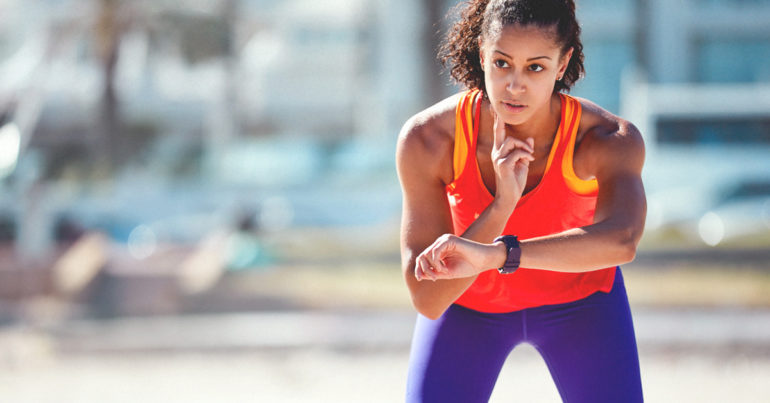 A person wearing a fitness tracker monitoring their heart rate during exercise.