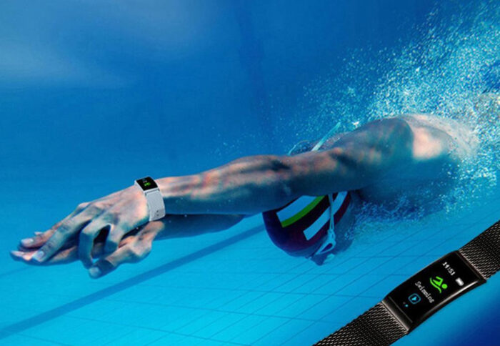 A person wearing a waterproof fitness band while swimming.