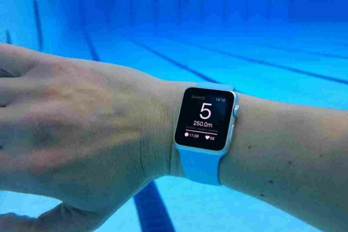 A waterproof fitness tracker on a person's wrist.