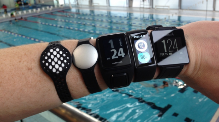 A waterproof fitness tracker on a swimmer's wrist.